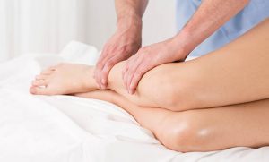 Physical therapist doing lymphatic drainage for the legs